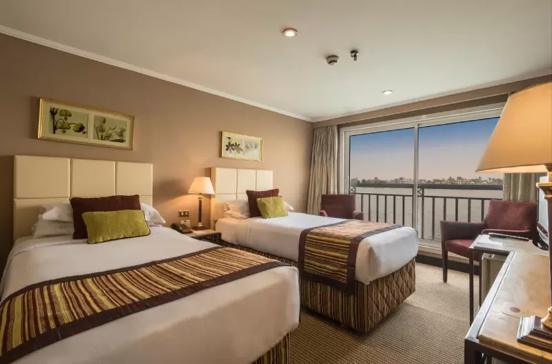 Elegant cabin interior aboard Jaz Crown Jewel Nile Cruise featuring panoramic Nile view